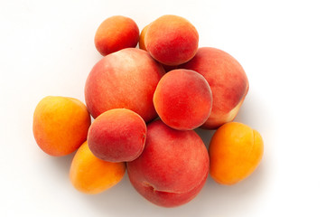 Fresh juicy peaches fruits and ripe apricots isolated on white background. Summer fruit concept. Close-up