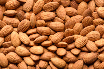 Peeled almonds closeup background. Top view