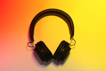 Fototapeta na wymiar Stylish headphones on color background, top view