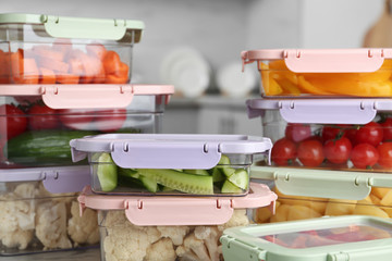 Boxes with fresh raw vegetables on table in kitchen
