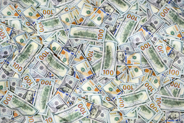 Pile of one hundred US dollar bills as background