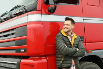 Portrait of happy driver at modern truck outdoors