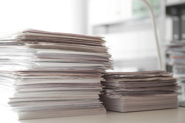 Stacks of documents on desk in office