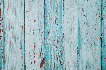 Wooden fence of blue color with cracks and texture of old paint. Background for your design