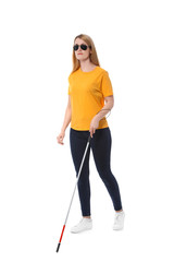 Blind woman in dark glasses with walking cane on white background
