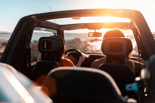 beautiful girls and young people traveling with the jeep car