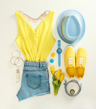 Flat lay composition with stylish summer clothes and accessories on light background