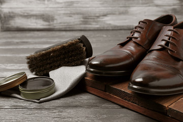 Footwear and shoe shine kit on grey table