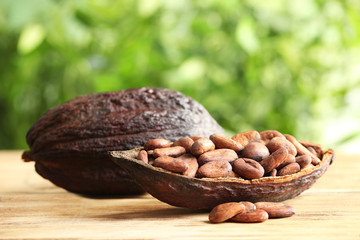 Cocoa pod with beans on wooden table