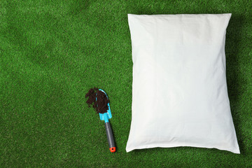 Bag with soil and shovel on green grass, flat lay. Gardening time