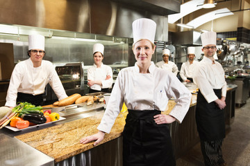 Portrait of chefs standing in commercial kitchen