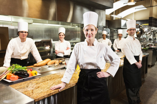 Portrait of chefs standing in commercial kitchen