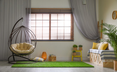 Stylish modern room interior with swing chair