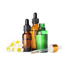 Bottles of herbal essential oils, chamomile flowers and pipette isolated on white