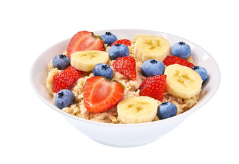 Bowl of oatmeal with berries, banana,blueberry and strawberry  on white background isolated.