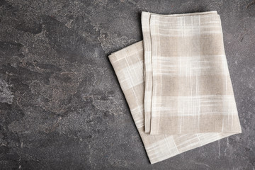Beige plaid kitchen towel on grey background, top view. Space for text