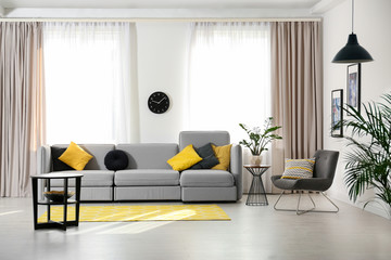 Stylish living room interior with comfortable sofa. Space for text