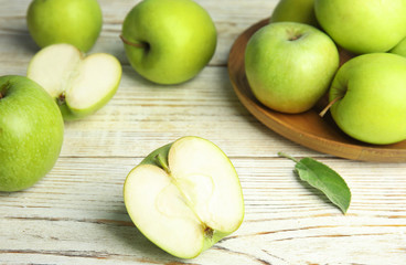 Fresh ripe green apples on white wooden table