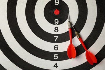Red arrows on dart board, top view