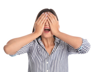 Young woman being blinded and covering eyes with hands on white background