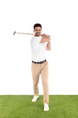 Young man playing golf on course against white background