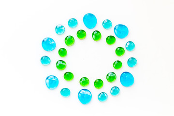 Pattern from colored glass stones on white background top view