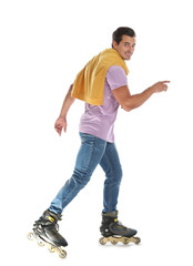 Naklejka premium Handsome young man with inline roller skates on white background