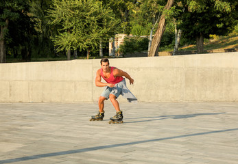 Handsome young man roller skating on city street, space for text