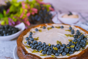 Cheesecake with blueberry, pumpkin seeds and cream