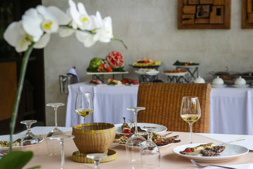 Banquet table with food and wine glasses. Table arranged for a dinner event 