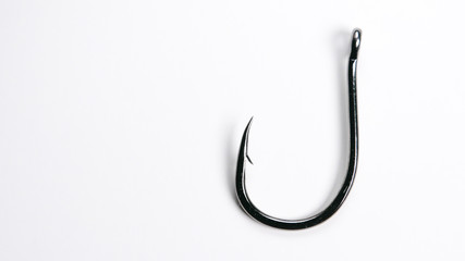 Fishing hook on white background with copy space on left