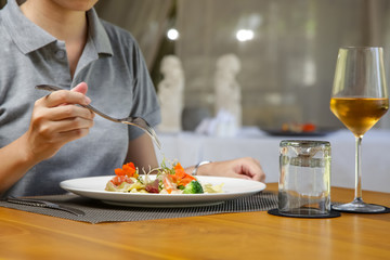 Obraz na płótnie Canvas Woman eating ravioli. Ravioli and glass of wine served on the restaurant table