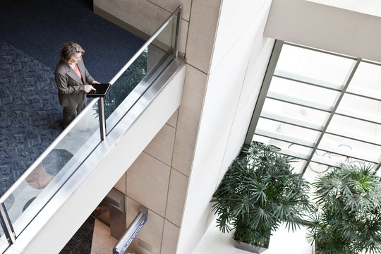 High angle view of businesswoman using digital tablet in convention center