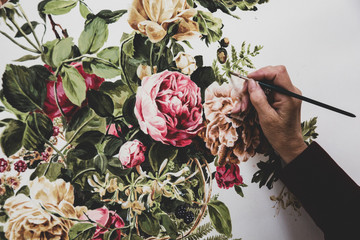 Close up of woman's hand painting on canvas