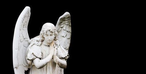 Guardian angel sculpture with open wings isolated on wide panorama banner black background with empty text space. Angel sad expression sculpture with eyes down and hands together in front of chest. - 281534975