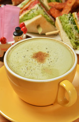 Matcha lattle and sandwich on the table   
