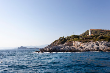 Fototapeta na wymiar a lighthouse, mountains and seascape in fethiye