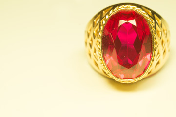 Golden ring with ruby on white background