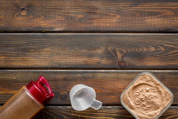 protein powder for fitness nutrition on wooden background top view mock-up