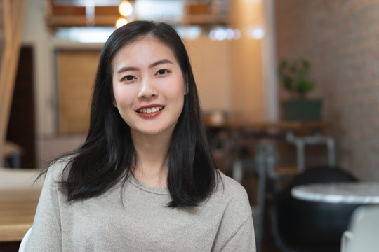 portrait photography asian young woman smile in cafe background.