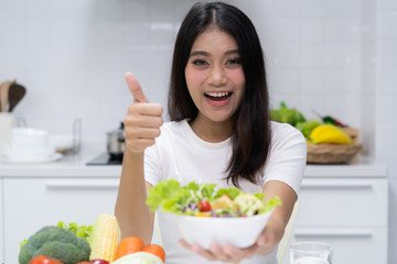 Fresh organic foods. Girl holding salad on bowl.