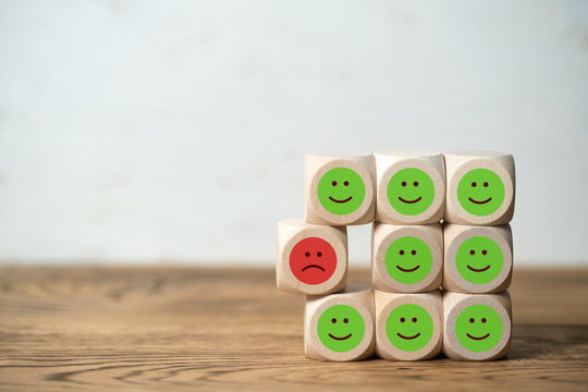 cubes with emoticons on wooden background 