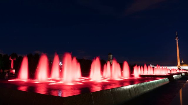 Fountains backlighted by red in Moscow in victory park.
