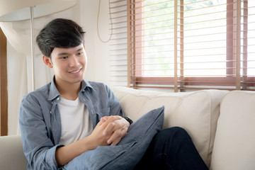 Portrait young handsome asian man napping relax with cozy on sofa at home, asia male resting and sleeping in weekend with tired and lazy on couch in vacation, lifestyle and wellbeing concept.
