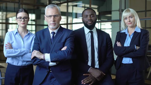Professional lawyers folding arms looking camera, business career, strategy