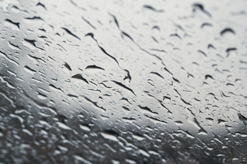 Raindrops on the window close up. rain drops on the glass macro. water drops falling down on window. rainy day