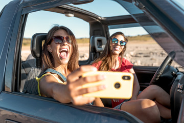 beautiful girls and young people traveling with the jeep car