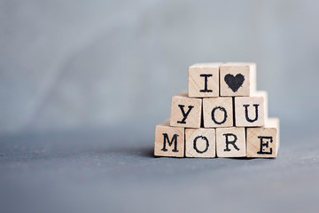 I heart you more written in stamp letters