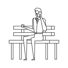 elegant businessman calling with smartphone seated in the park chair
