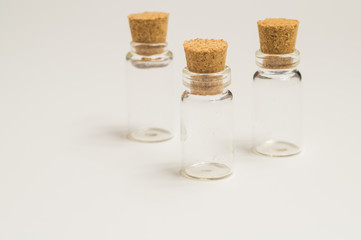 Empty little bottles with cork stopper on white background. transparent containers. test tubes